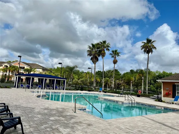 a view of a kitchen with refrigerator and wooden floor
