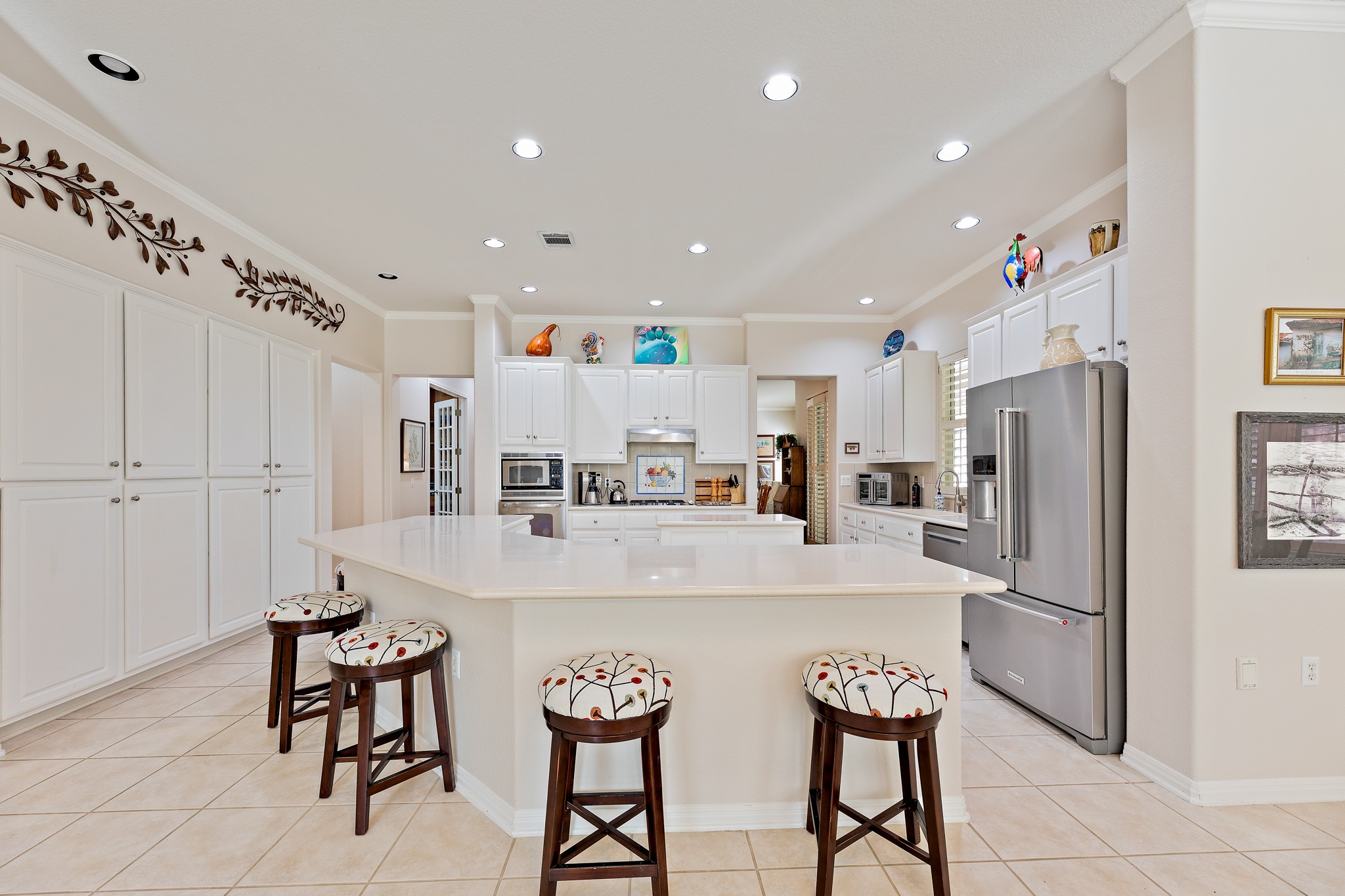 106 Wild Turkey Lane Georgetown, TX 78633 - Photo 12 of 39 a kitchen with stainless steel appliances a refrigerator sink and white cabinets