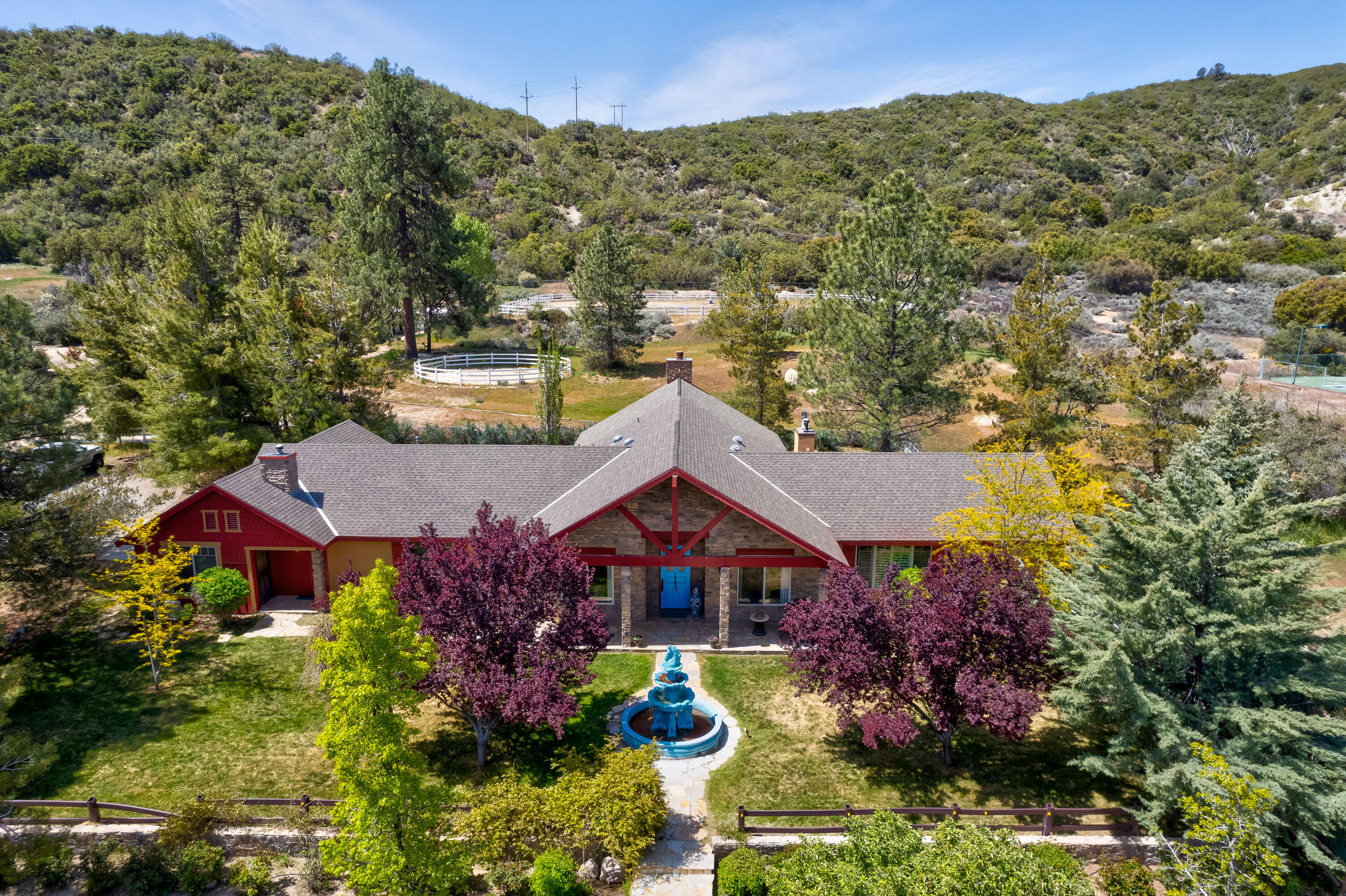 59985 Hop Patch Spring Road Mountain Center, CA 92561 - Photo 1 of 63 a aerial view of a house with a big yard and large trees