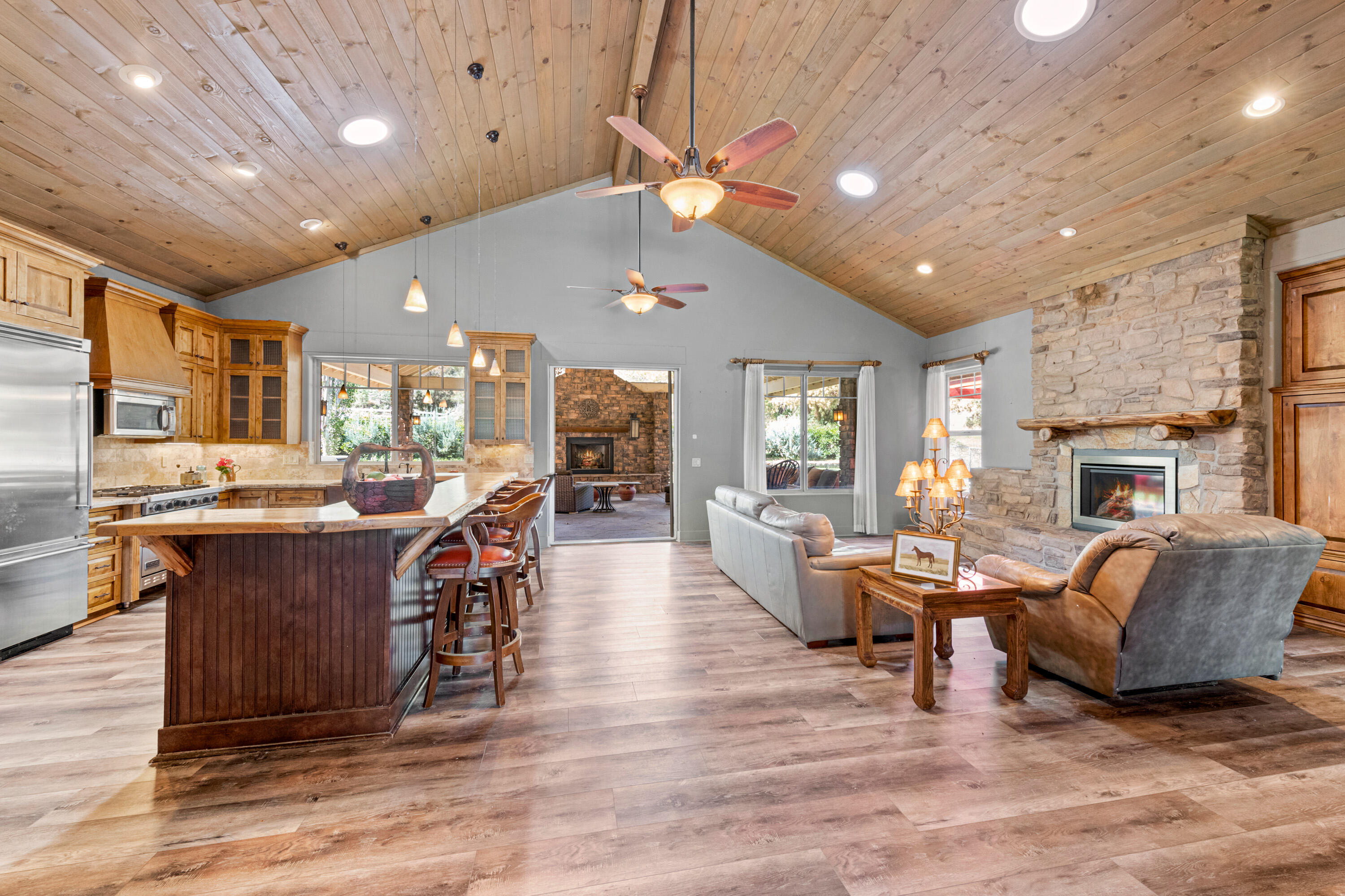 59985 Hop Patch Spring Road Mountain Center, CA 92561 - Photo 14 of 63 a living room with furniture a fireplace and a dining table with wooden floor