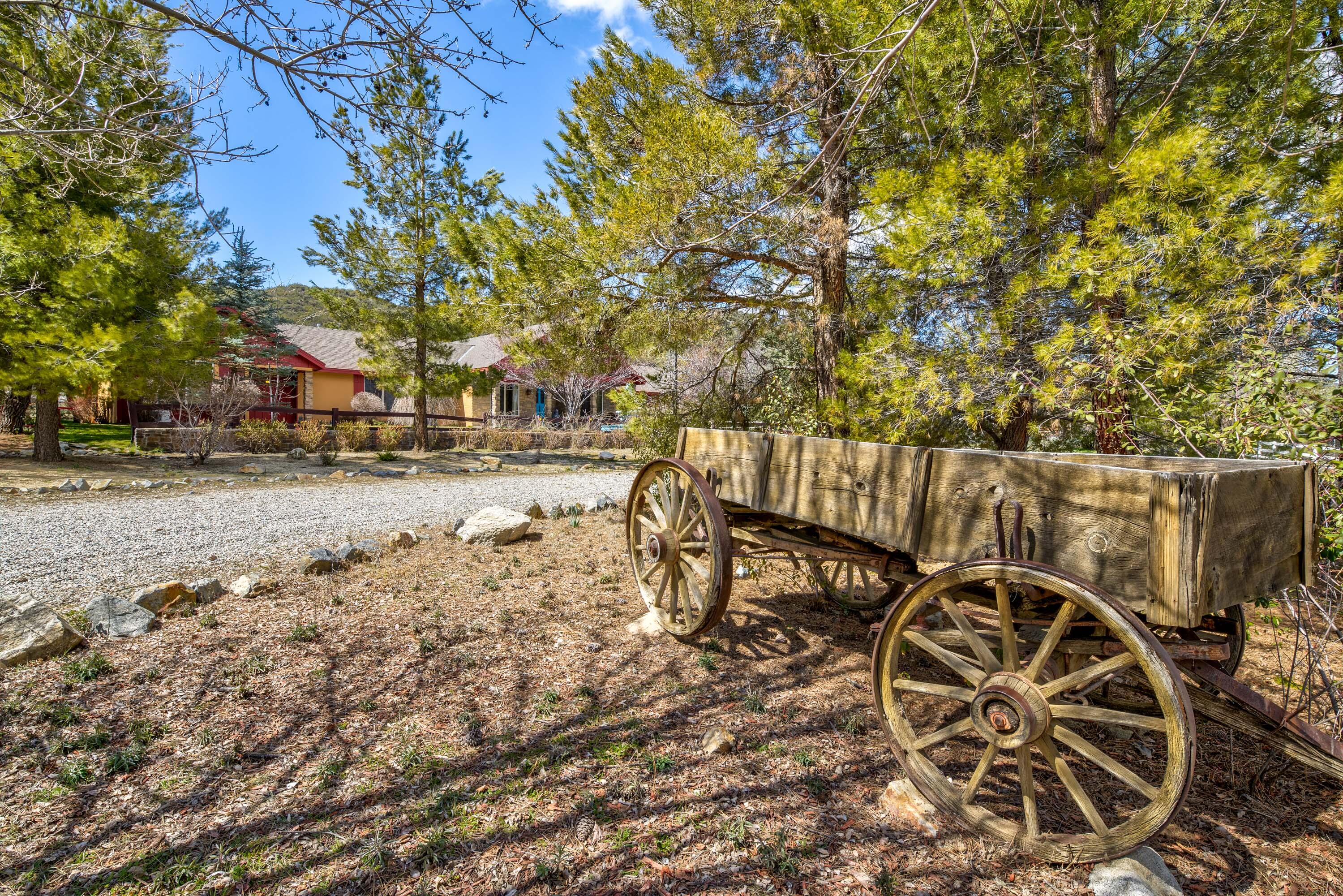 59985 Hop Patch Spring Road Mountain Center, CA 92561 - Photo 2 of 63 a view of a patio with table and chairs with wooden fence and plants