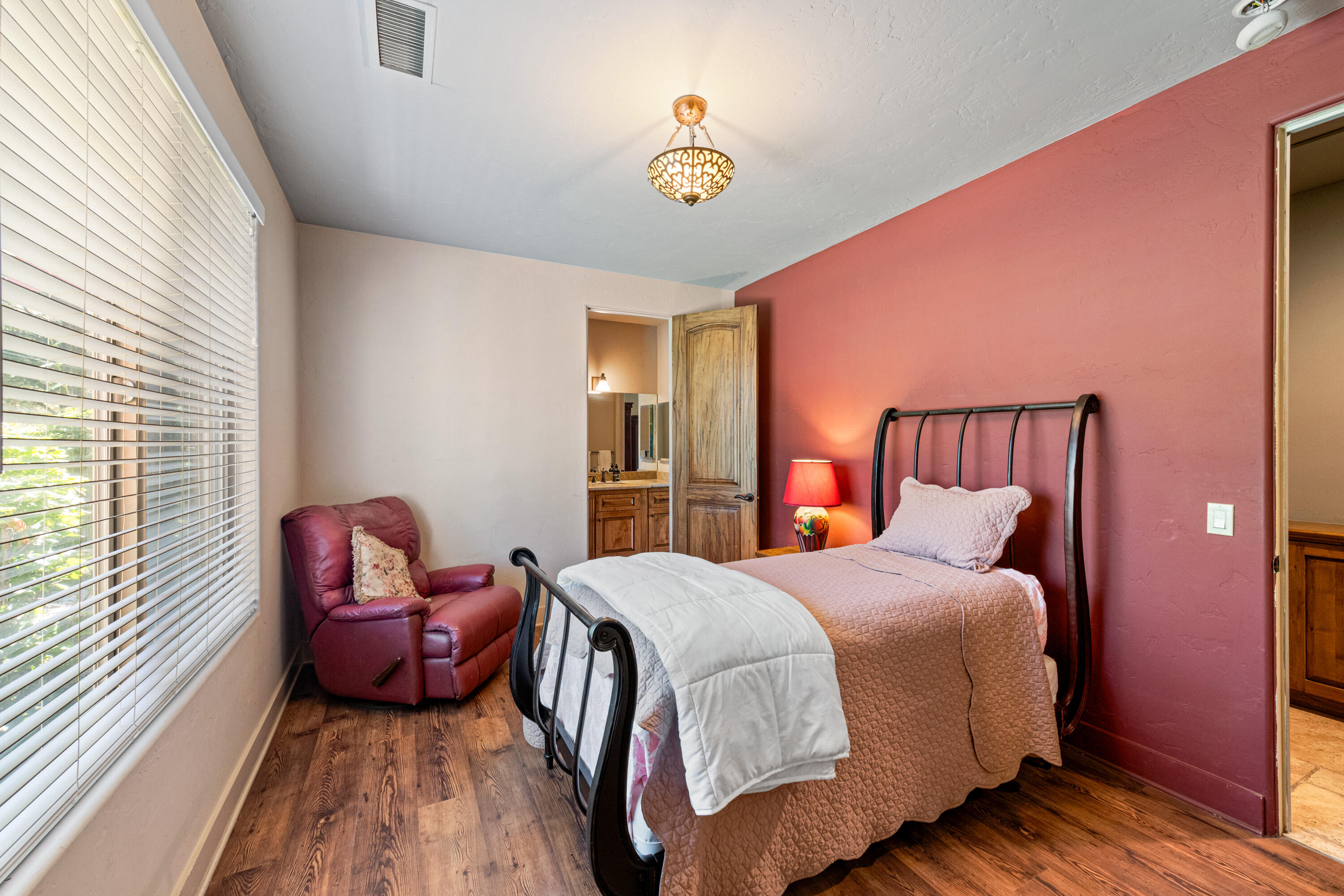 59985 Hop Patch Spring Road Mountain Center, CA 92561 - Photo 22 of 63 a bedroom with a bed and a chandelier