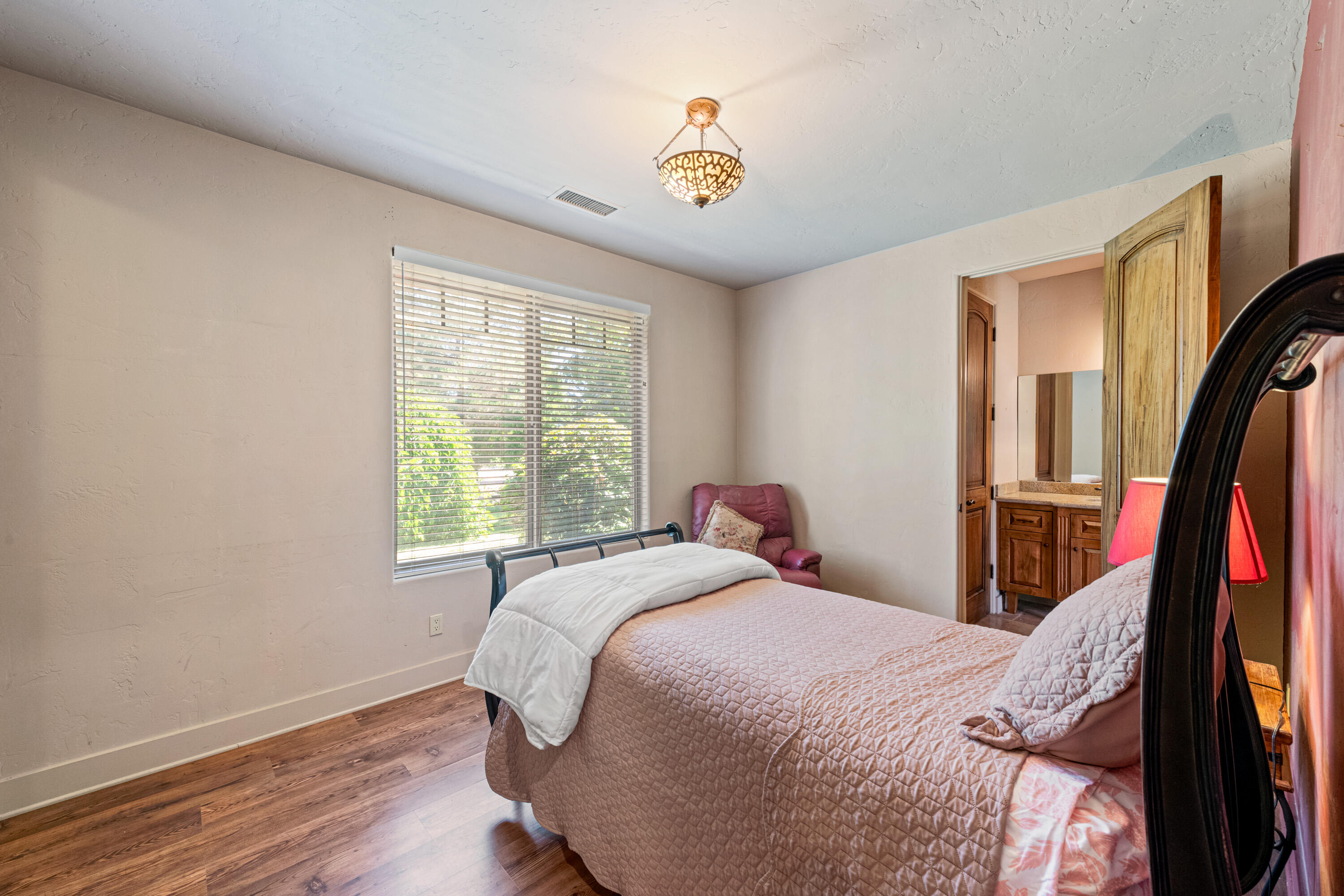 59985 Hop Patch Spring Road Mountain Center, CA 92561 - Photo 24 of 63 a bed sitting in a bedroom next to a window