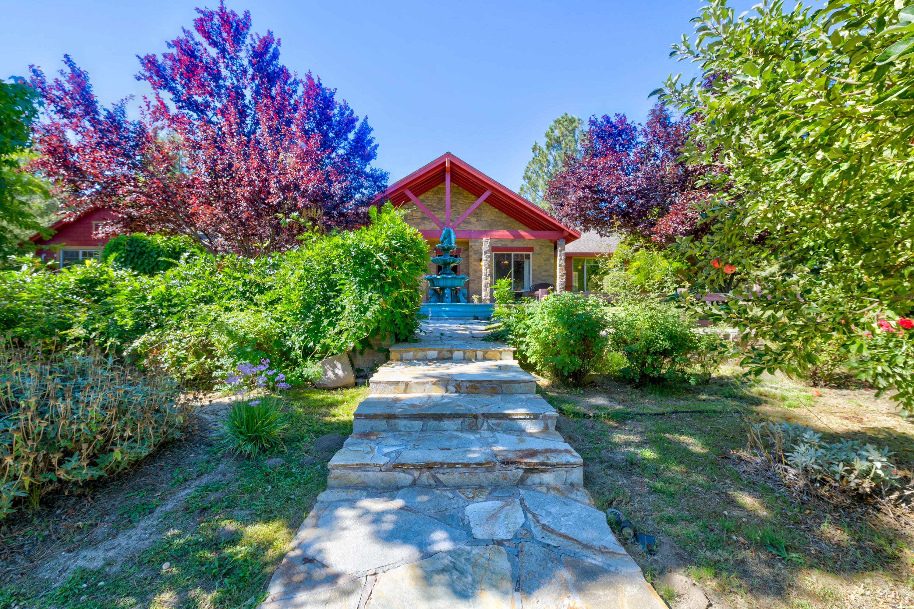 59985 Hop Patch Spring Road Mountain Center, CA 92561 - Photo 3 of 63 a front view of a house with a yard and potted plants