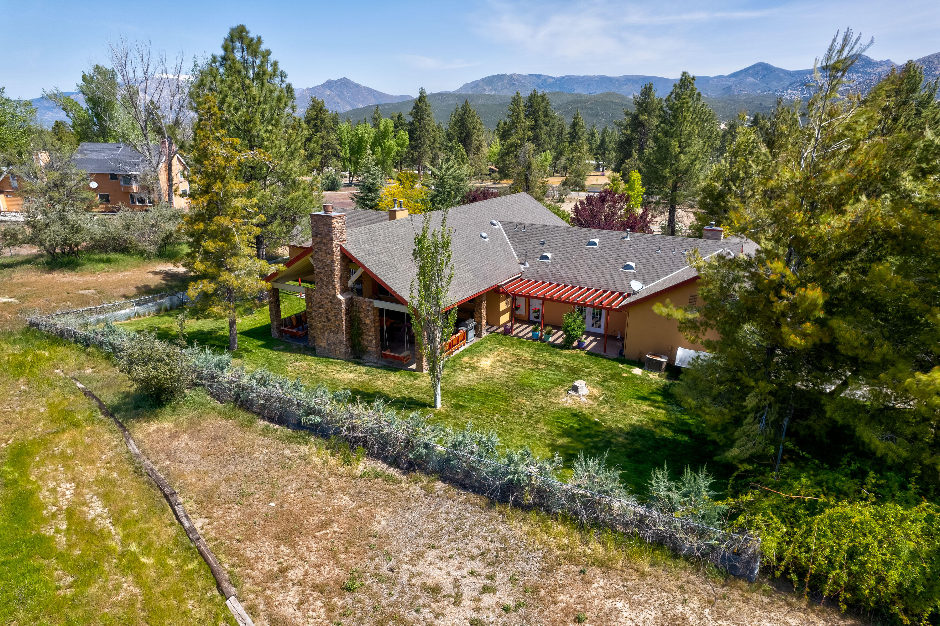 59985 Hop Patch Spring Road Mountain Center, CA 92561 - Photo 55 of 63 a aerial view of a house with a yard and a large tree