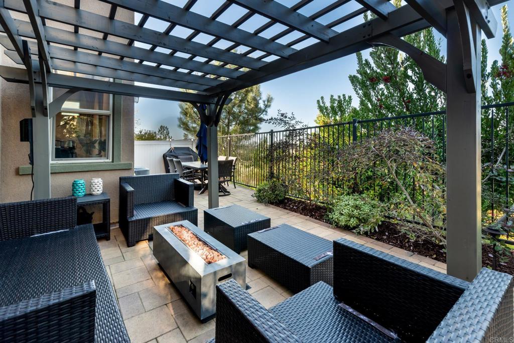 1244 Via Candelas Oceanside, CA 92056 - Photo 16 of 60 a living room with patio furniture and a floor to ceiling window
