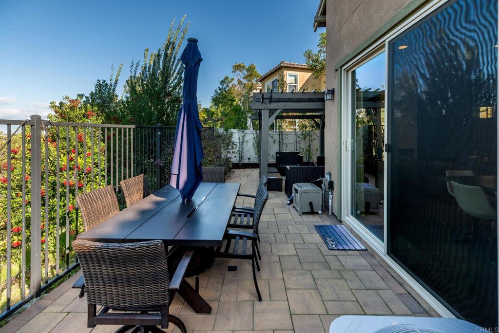 1244 Via Candelas Oceanside, CA 92056 - Photo 18 of 60 a view of a patio with table and chairs with wooden floor and fence