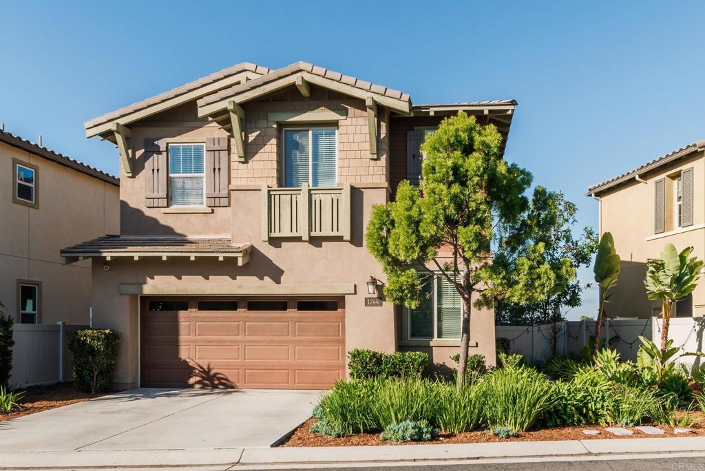 1244 Via Candelas Oceanside, CA 92056 - Photo 2 of 60 a front view of a house with a yard