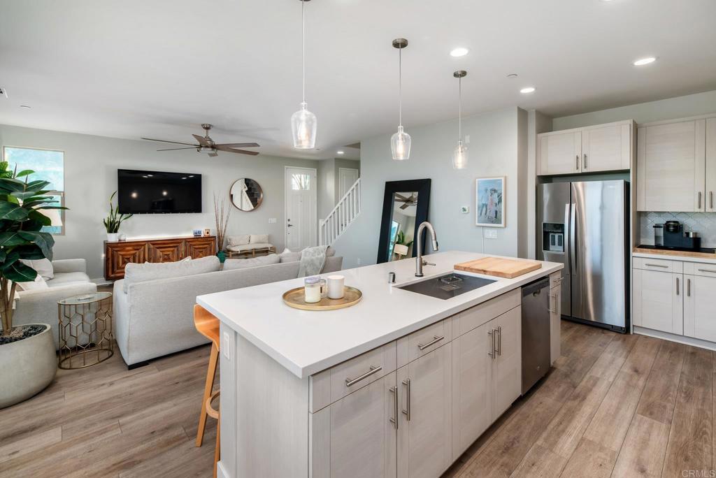 1244 Via Candelas Oceanside, CA 92056 - Photo 31 of 60 a kitchen with a sink stove and refrigerator