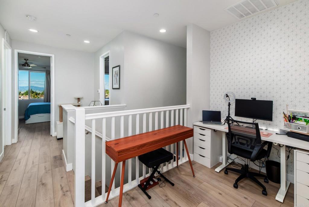 1244 Via Candelas Oceanside, CA 92056 - Photo 34 of 60 a view of a workspace with furniture and wooden floor