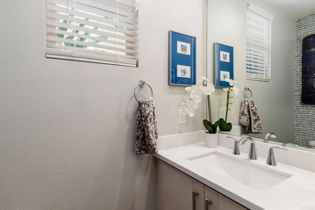 1244 Via Candelas Oceanside, CA 92056 - Photo 35 of 60 a bathroom with a granite countertop sink and a mirror