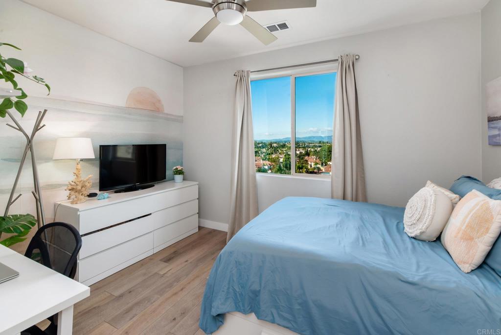 1244 Via Candelas Oceanside, CA 92056 - Photo 42 of 60 a bedroom with a bed and a flat screen tv