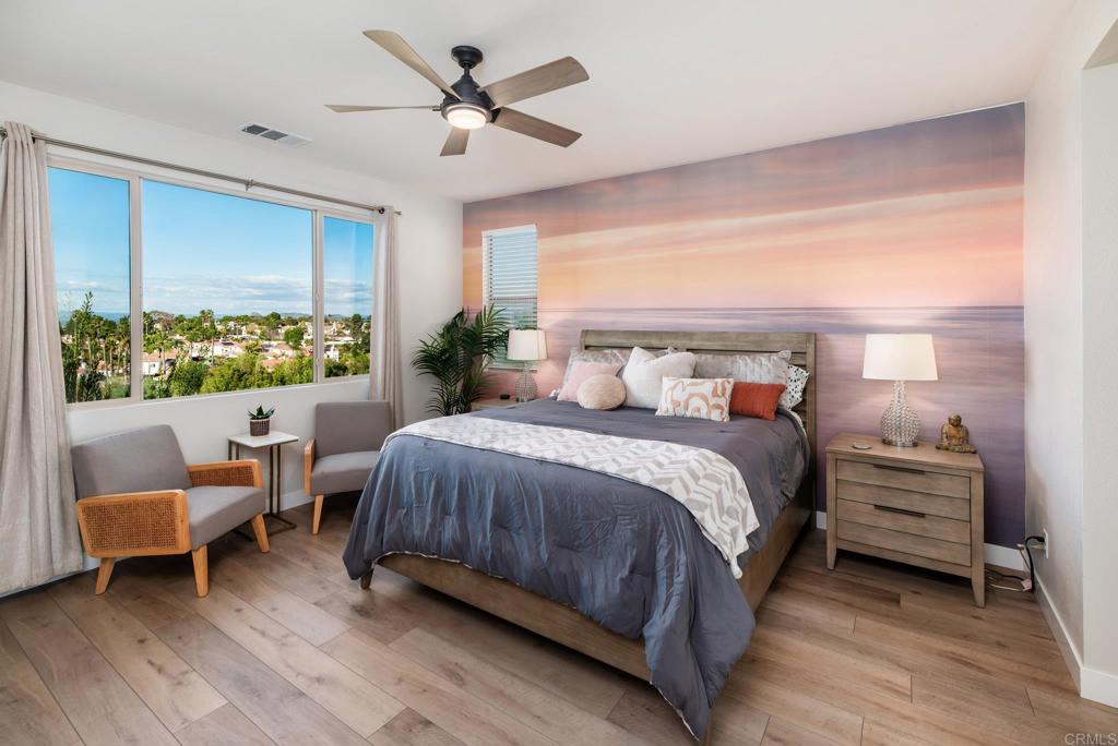 1244 Via Candelas Oceanside, CA 92056 - Photo 44 of 60 a spacious bedroom with a bed a couch and a window