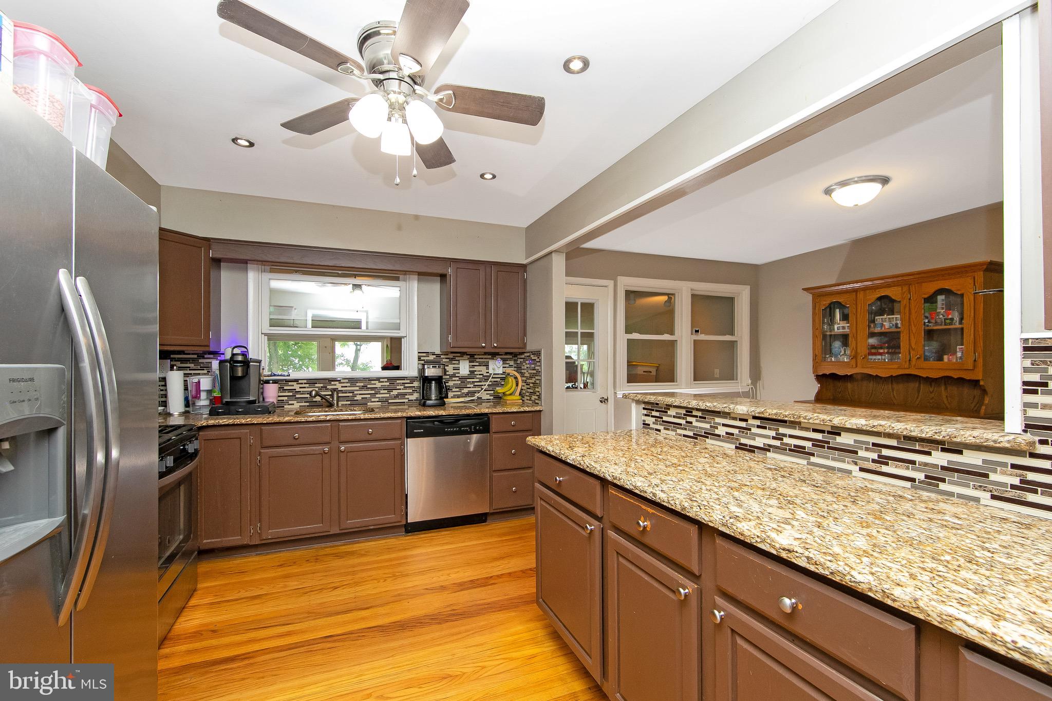 421 Yorkshire Road Cherry Hill, NJ 08034 - Photo 11 of 38 a kitchen with stainless steel appliances granite countertop a sink stove and refrigerator