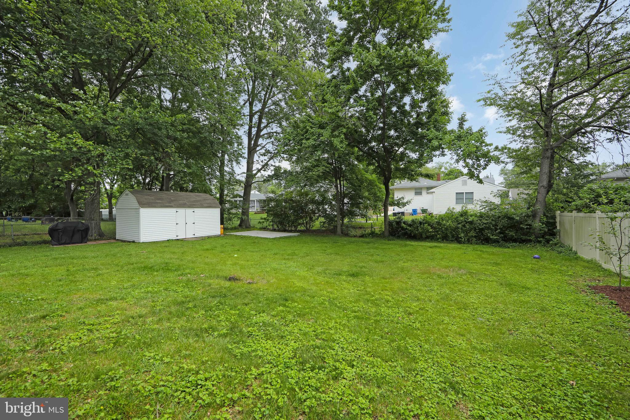 421 Yorkshire Road Cherry Hill, NJ 08034 - Photo 38 of 38 a backyard of a house with lots of plants and large tree