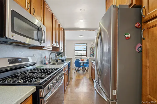 a kitchen with stainless steel appliances granite countertop a refrigerator and a stove