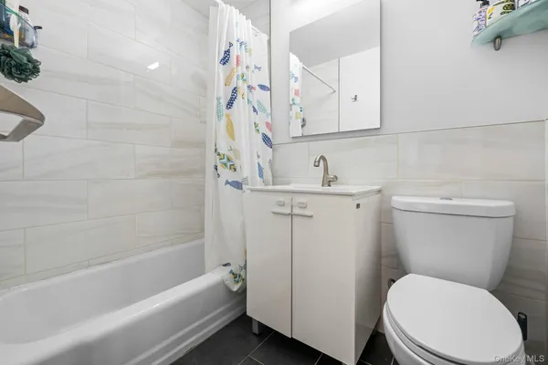 a bathroom with a sink a toilet and bathtub