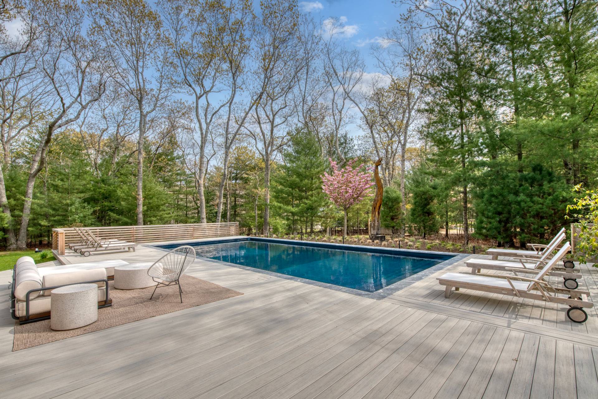 16 4th Street East Hampton, NY 11937 - Photo 14 of 18 a view of a patio with chairs and wooden fence