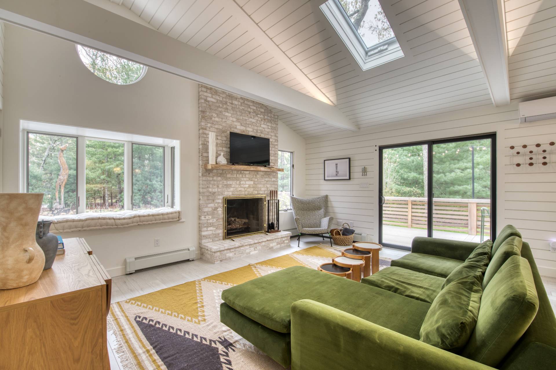 16 4th Street East Hampton, NY 11937 - Photo 8 of 18 a living room with furniture large window and a fireplace