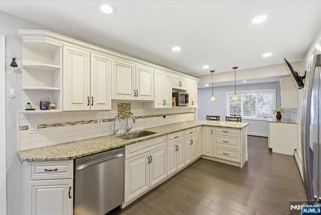 a kitchen with granite countertop white cabinets and white appliances