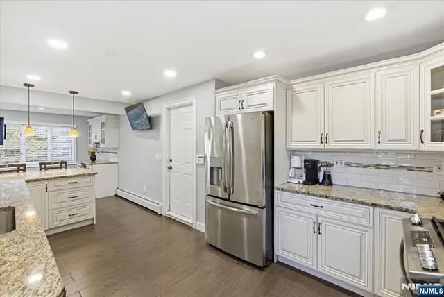 a kitchen with granite countertop cabinets and refrigerator