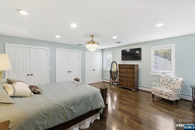 a bedroom with a bed and a television