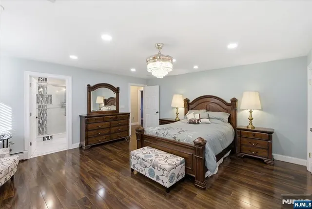 a bedroom with bed and wooden floor