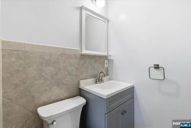a bathroom with a sink a toilet and mirror