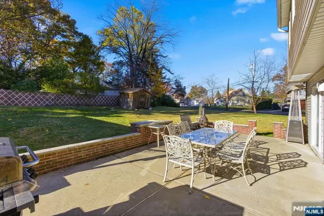 a view of a swimming pool with lawn chairs and a yard
