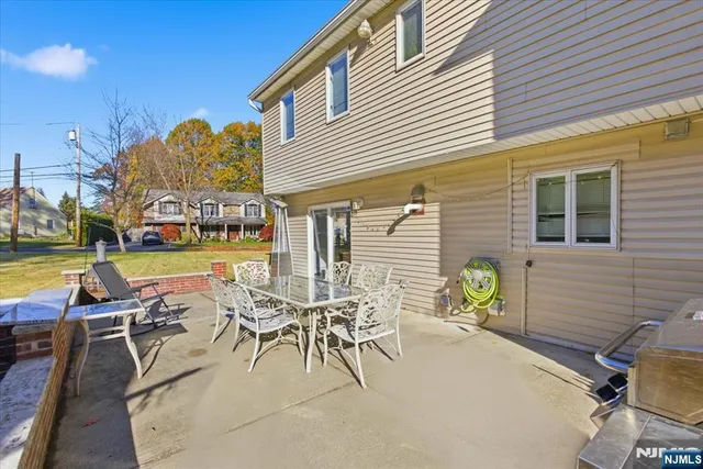 a view of a chairs and table in patio with a swimming pool
