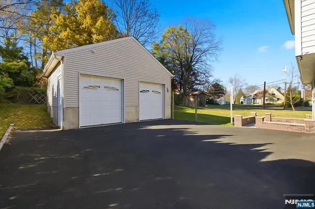 a view of a house with a yard and garage