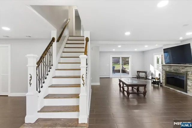 a view of a livingroom with furniture fireplace and wooden floor