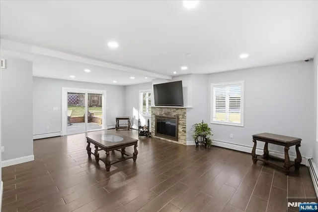 a living room with fireplace furniture and a wooden floor