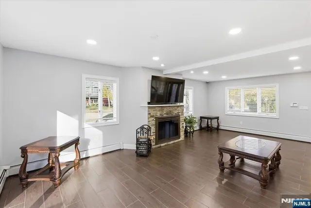 a living room with furniture a fireplace and a flat screen tv