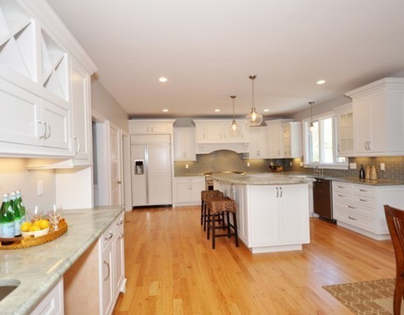255 Deacon Haynes Road Concord, MA 01742 - Photo 10 of 22 a kitchen with stainless steel appliances kitchen island granite countertop a stove a sink and a refrigerator