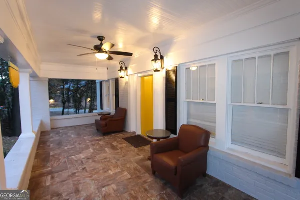 a living room with furniture a chandelier and a large window