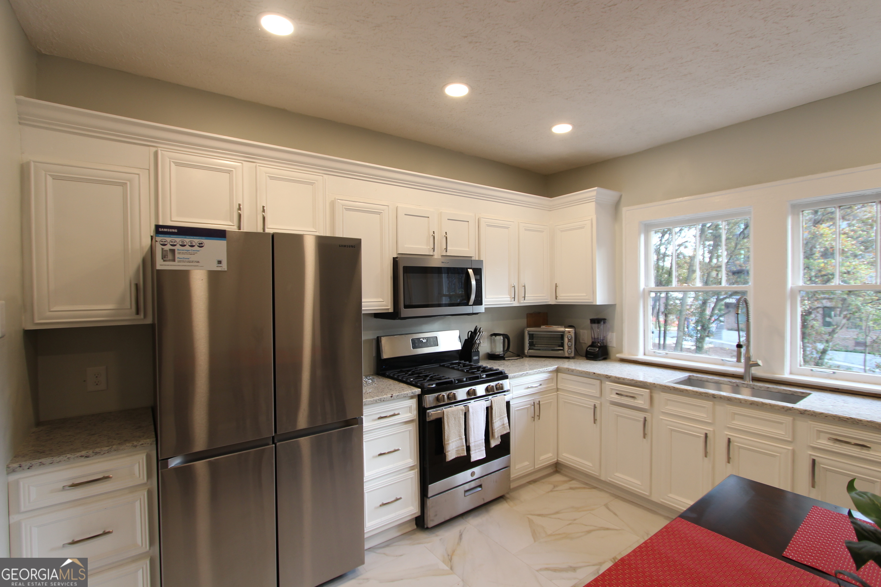 997 Boulevard Southeast Atlanta, GA 30315 - Photo 5 of 20 a kitchen with stainless steel appliances granite countertop a refrigerator sink and microwave