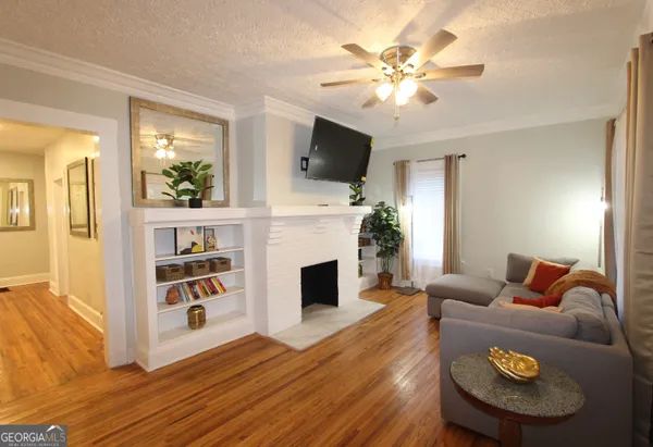 a living room with furniture fireplace and flat screen tv