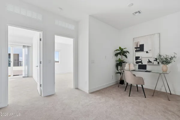 a view of work space with furniture and a potted plant