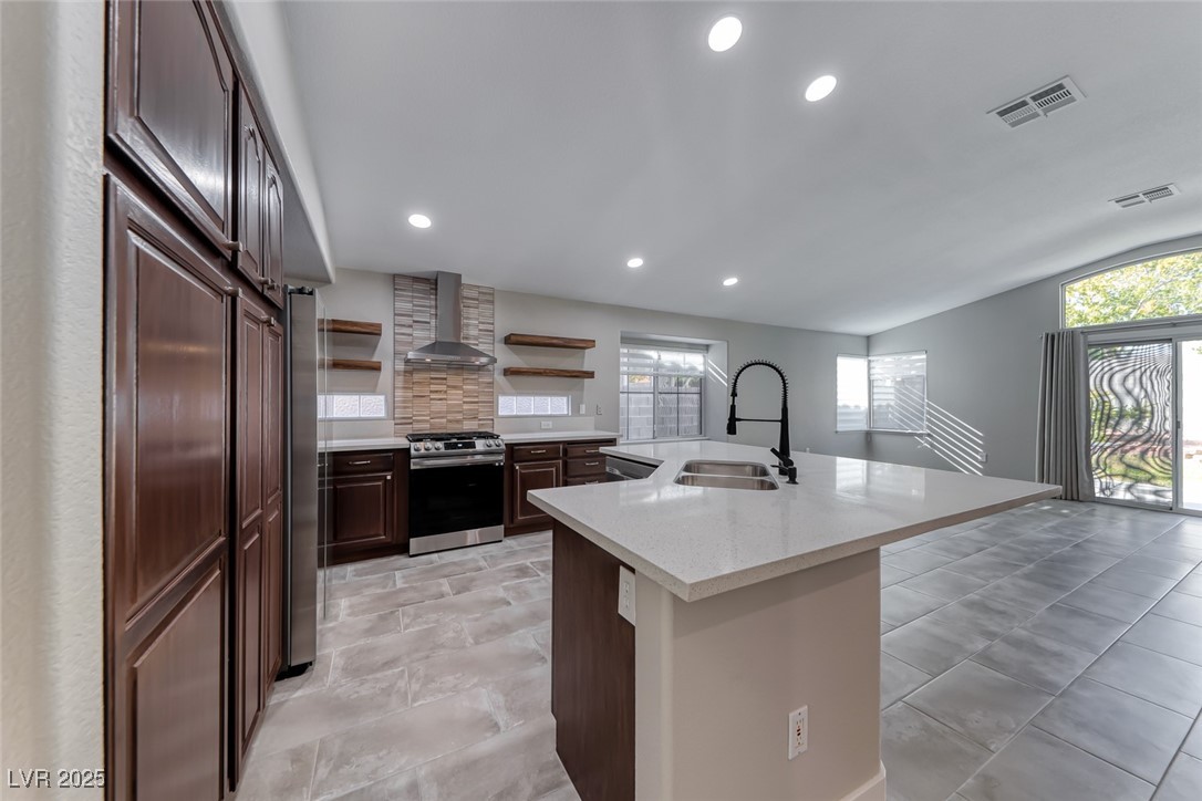 2401 Flower Spring Street Las Vegas, NV 89134 - Photo 19 of 42 Kitchen with open shelves, stainless steel appliances, recessed lighting, wall chimney range hood, and decorative backsplash