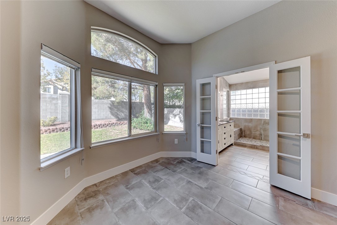 2401 Flower Spring Street Las Vegas, NV 89134 - Photo 26 of 42 Unfurnished bedroom featuring baseboards and french doors