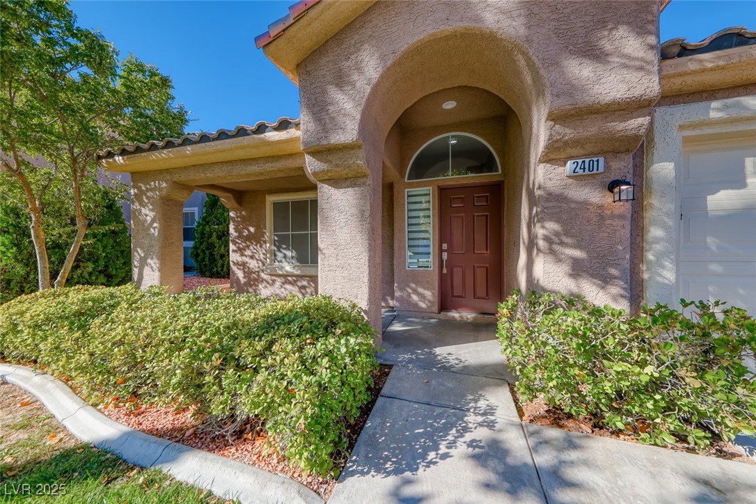 2401 Flower Spring Street Las Vegas, NV 89134 - Photo 5 of 42 Doorway to property with a tiled roof