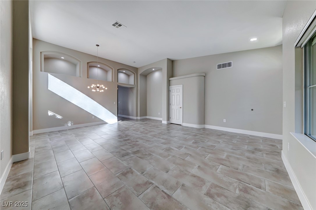 2401 Flower Spring Street Las Vegas, NV 89134 - Photo 6 of 42 Spare room with a chandelier, recessed lighting, and light tile patterned floors