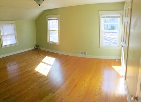 284 Plumtree Road Springfield, MA 01118 - Photo 4 of 8 a view of empty room with wooden floor and fan