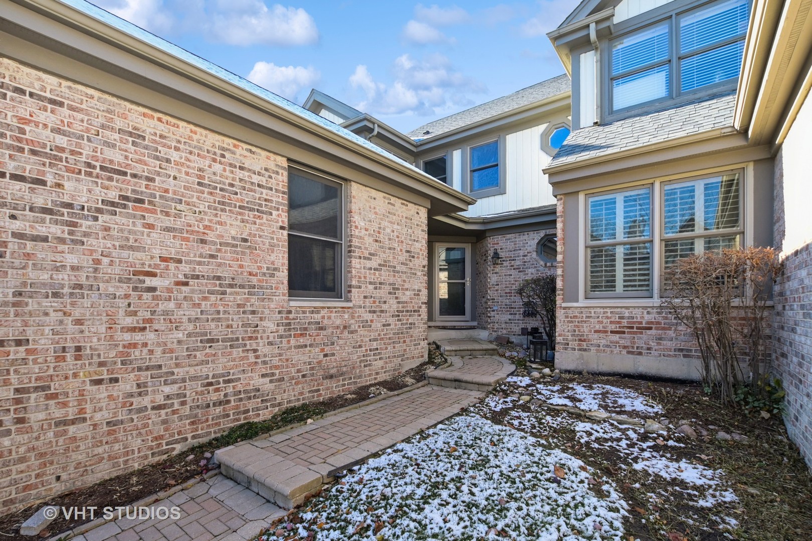 14740 Pine Tree Road Orland Park, IL 60462 - Photo 2 of 25 a brick building with a door and a bench