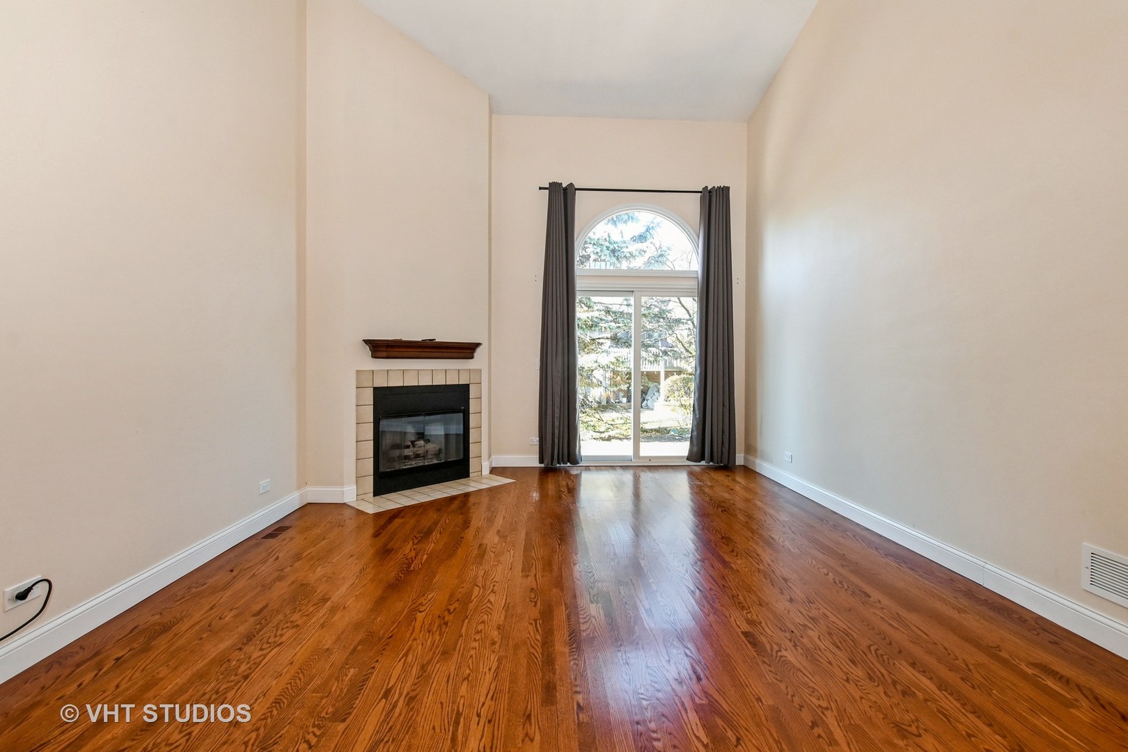 14740 Pine Tree Road Orland Park, IL 60462 - Photo 3 of 25 an empty room with wooden floor fireplace and windows