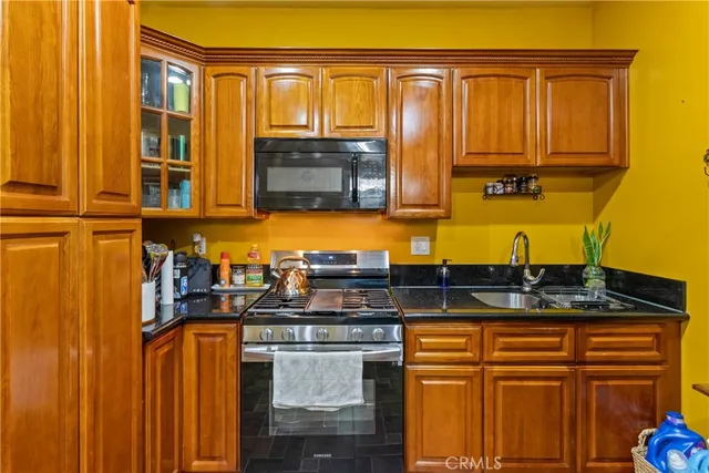 a kitchen with stainless steel appliances granite countertop a sink and cabinets
