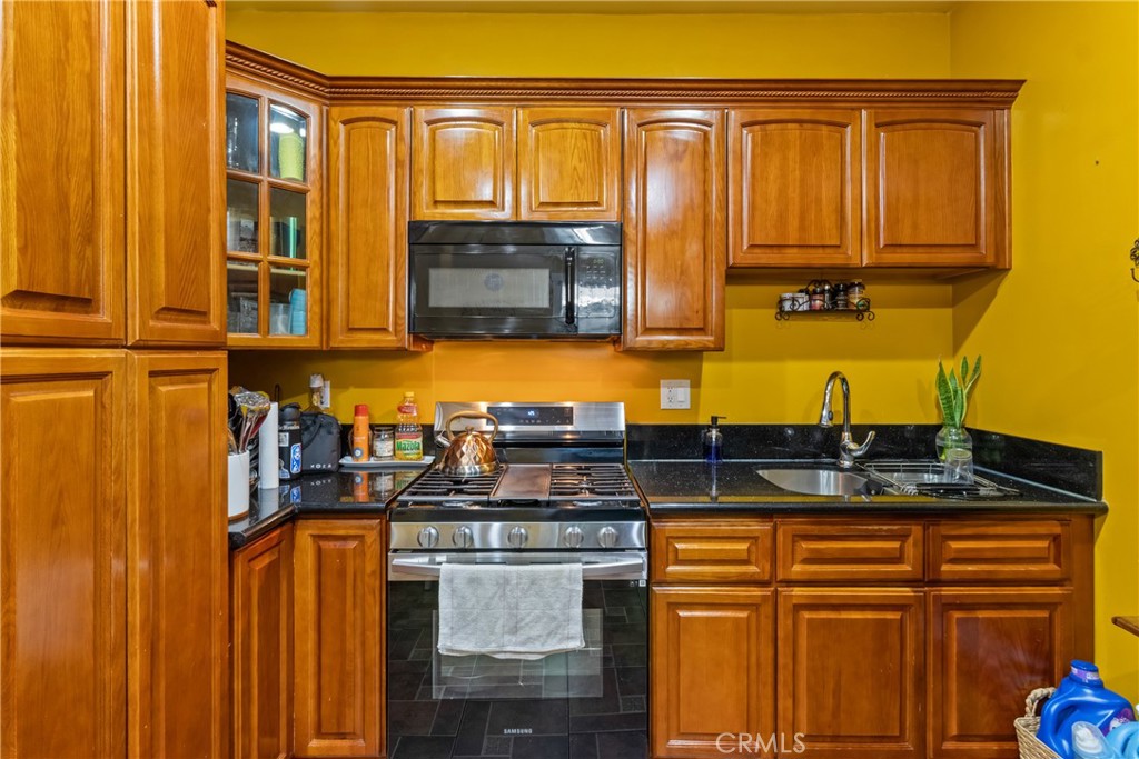 63 Yale Street Pasadena, CA 91103 - Photo 11 of 50 a kitchen with stainless steel appliances granite countertop a sink and cabinets