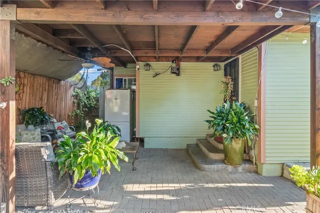 a view of a backyard with plants and a grill