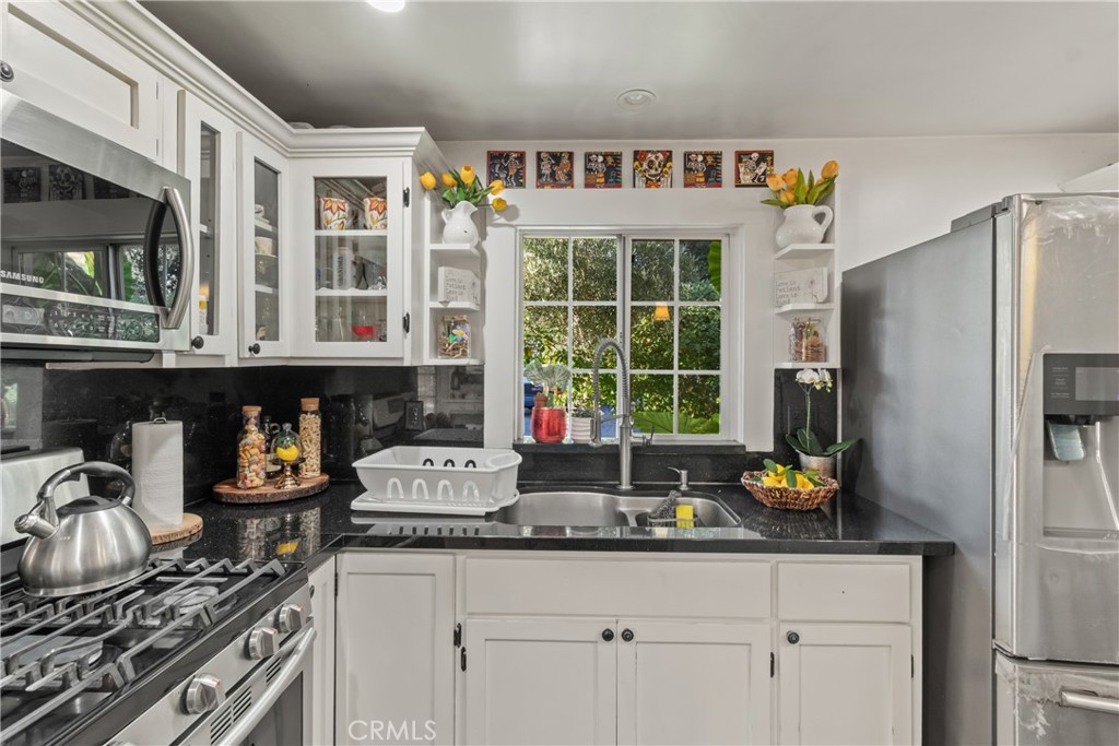 63 Yale Street Pasadena, CA 91103 - Photo 25 of 50 a kitchen with stainless steel appliances granite countertop a sink stove and refrigerator